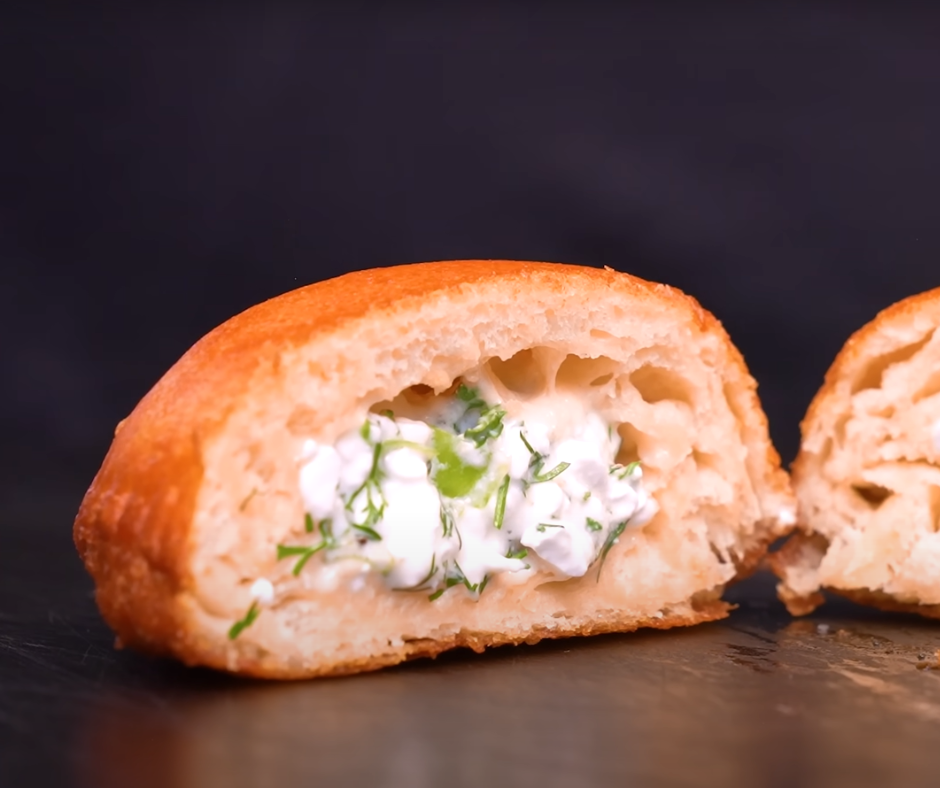 Cut open cottage cheese and herb empanadas