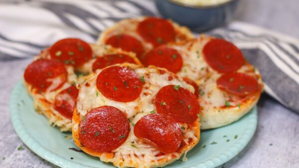 Pepperoni pizza bagels on a plate
